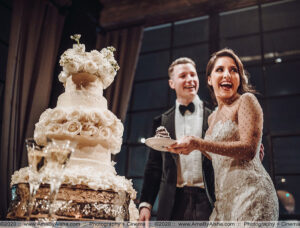 couple cuts wedding cake captured by houston wedding photographer